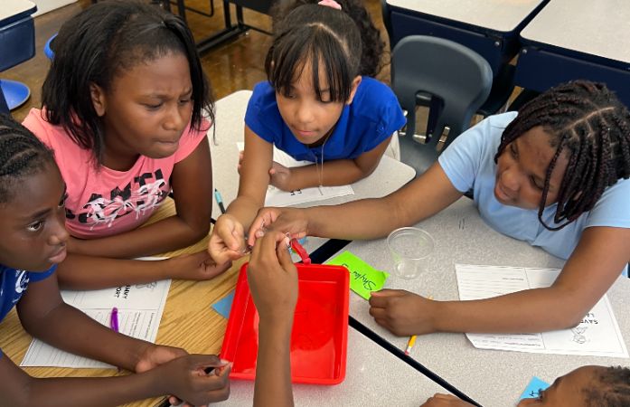  Five Students working together to Save Sammy the Worm.